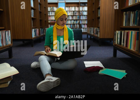 Young woman studying in library Stock Photo