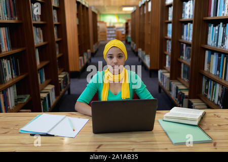 Young woman studying in library Stock Photo