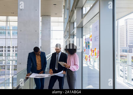 Diverse business team discussing plans in a modern office Stock Photo
