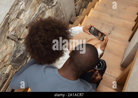 Couple taking selfie on stairs Stock Photo