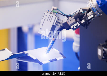 Automatic welding robot in a modern factory in operation. Stock Photo
