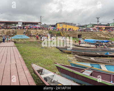 Tabatinga, Brazil - November 25, 2018: People and wooden boat in  the port of Amazon river. South America. Amazon River.  Tres fronteras. Rain Forest Stock Photo