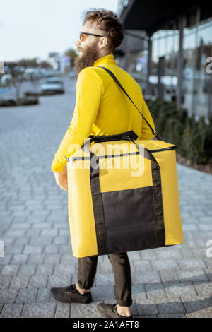 Download Courier Carrying Yellow Thermal Bag Delivering Food In The City Close Up View With Copy Space Delivery Service Concept Stock Photo Alamy PSD Mockup Templates