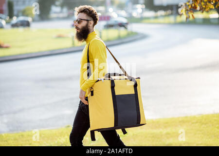 Download Courier Carrying Yellow Thermal Bag Delivering Food In The City Close Up View With Copy Space Delivery Service Concept Stock Photo Alamy Yellowimages Mockups
