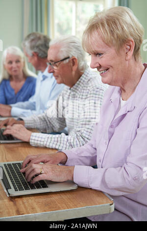 Senior Woman With Tutor In Computer Class Stock Photo