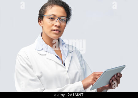 Studio Portrait Of Female Laboratory Technician Working With Digital Tablet Stock Photo