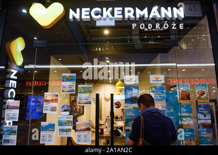 A man looks to travel offers at Neckermann travel agency. Polish travel agency Neckermann, which is owned by bankrupt British firm Thomas Cook, has filed for insolvency, Flights have been suspended and it no longer takes new bookings. Around 3,600 of its customers are currently on holiday abroad. Stock Photo