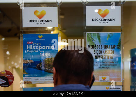 A man looks to travel offers at Neckermann travel agency. Polish travel agency Neckermann, which is owned by bankrupt British firm Thomas Cook, has filed for insolvency, Flights have been suspended and it no longer takes new bookings. Around 3,600 of its customers are currently on holiday abroad. Stock Photo