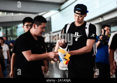 American professional basketball player Jeremy Shu-How Lin, right, arrives at an airport in Beijing to start his tenth career year in Beijing Ducks of Chinese Basketball Association (CBA), Beijing, China, 25 September 2019. Stock Photo
