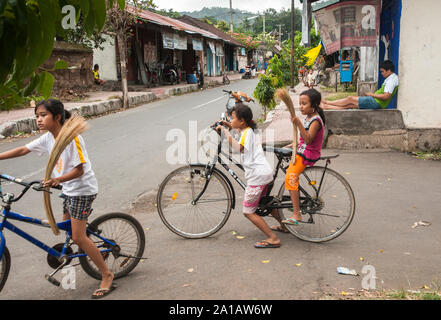 children playing in the street, in the Bali Aga village of Tenganan, near Candi Dasa, Eastern Bali, Indonesia. Stock Photo