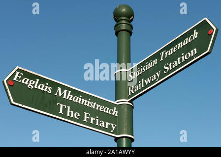 Cast iron fingerpost or sign post for the Friary and the Railway Station in Killarney, County Kerry, Ireland Stock Photo