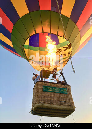 Hot-air balloon lifting off in field near Braunton, Devon, England, United Kingdom Stock Photo