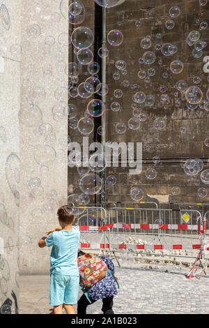 Kids playing with big bubbles in Prague, Czech Republic Stock Photo