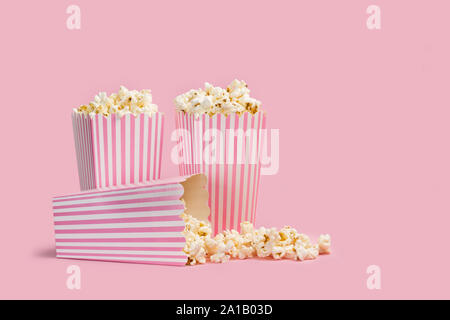 Popcorn in buckets on a pink background Stock Photo
