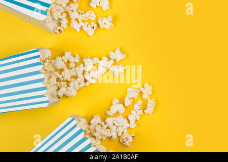 Popcorn in buckets on a yellow background Stock Photo