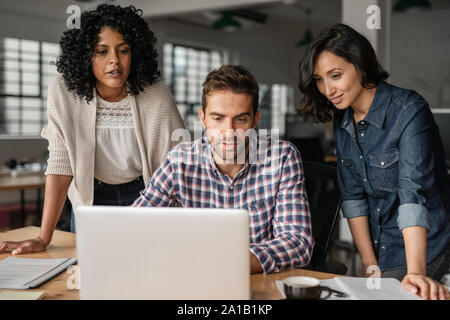 Diverse young designers working online with an office laptop Stock Photo