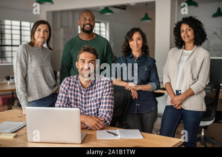 Smiling team of diverse designers working together in an office Stock Photo