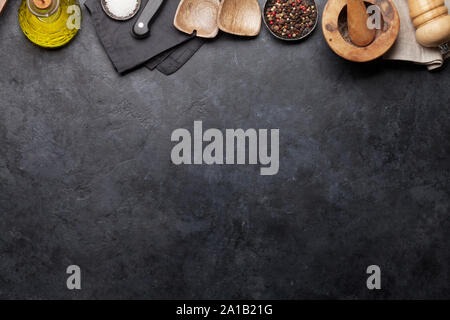 Cooking utensils and spices on stone kitchen table. Top view with copy space for your recipe Stock Photo