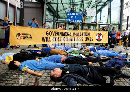 London, UK. 25th September, 2019. Doctors protesting with Extinction Rebellion glued themselves to a government building to protest against the threat of climate change on global health. This group of doctors & health professionals are calling for action to the 'impending public health crisis arising from climate and ecological breakdown'. Credit Gareth Morris/Alamy Live News Stock Photo