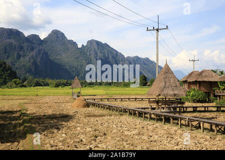Vieng Tara Villa. Rice fields with stunning mountain back drop. Vang Vieng. Laos. Asia. Stock Photo