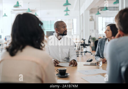 Diverse businesspeople having a meeting at an office table Stock Photo
