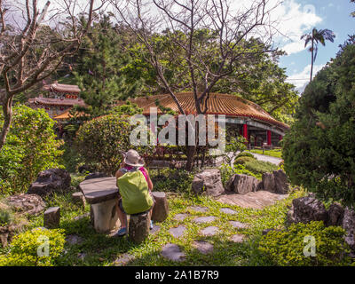 Maokong, Taiwan - October 19, 2016: Women with racksack in the park of  the Chih Nan Temple on the hills of Maokong  in Taiwan. Asia Stock Photo
