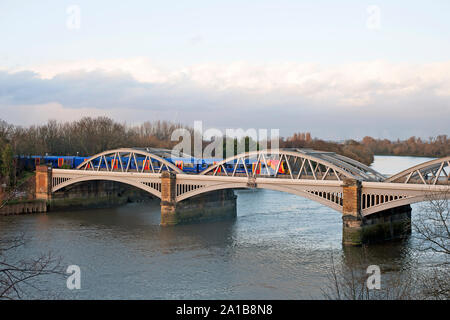 Elevated view of west side of Barnes Railway  Bridge, London SW13 over the River Thames with train crossing. Stock Photo