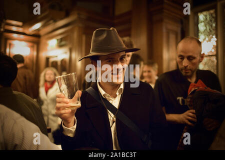 Portrait of a smiling young man holding an empty glass. Stock Photo