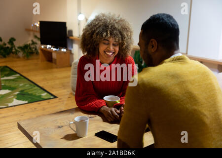 Millennial adult couple sitting together at home Stock Photo