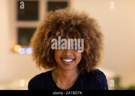 Portrait of millennial woman smiling at home Stock Photo