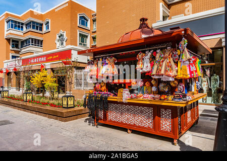 Urumqi International Grand Bazaar Shop Kiosk Selling Uyghur Souvenirs on a Sunny Blue Sky Day Stock Photo