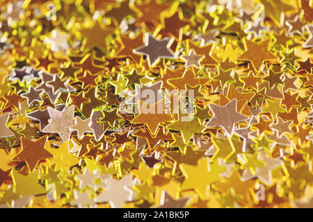 Close up background of golden and silver stars. Festive concept. Stock Photo