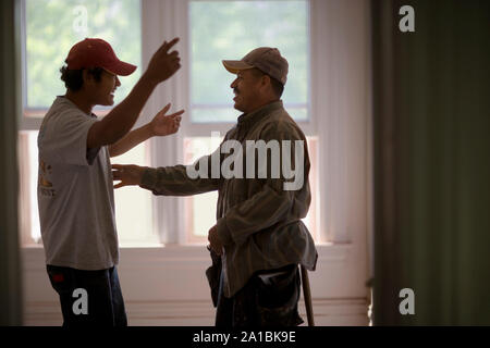 Two male builders sharing a joke. Stock Photo
