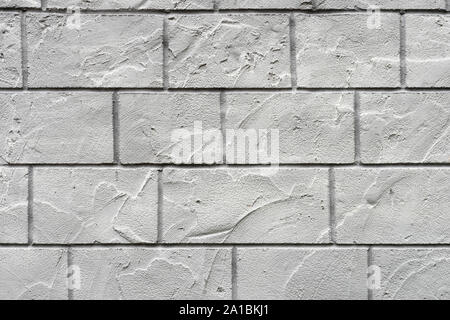 Horizontal concrete wall textured background. White grey rustic color.  Grungy Shabby Uneven Painted Plaster. Stock Photo