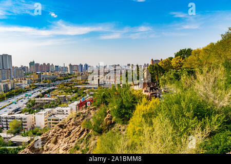 Urumqi Hong Shan Red Mountain Park with Lin Zexu Statue and Cityscape at Background on a Sunny Blue Sky Day Stock Photo