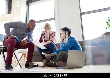 Multi-ethnic team of creative millenials collaborating on a brainstorm project Stock Photo