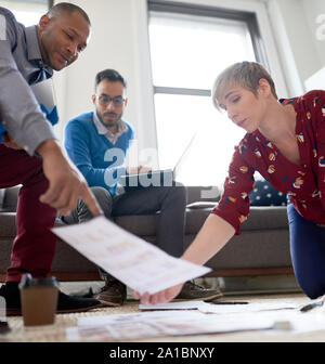 Multi-ethnic team of creative millenials collaborating on a brainstorm project Stock Photo