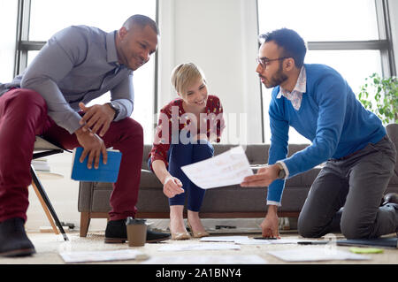 Multi-ethnic team of creative millenials collaborating on a brainstorm project Stock Photo