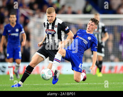 Grimsby Town's Eliott Whitehouse (left) and Chelsea's Billy Gilmour battle for the ball during the Carabao Cup, Third Round match at Stamford Bridge, London. Stock Photo