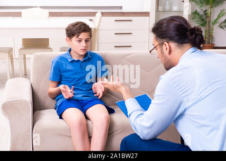 The internet addicted boy visiting male doctor Stock Photo