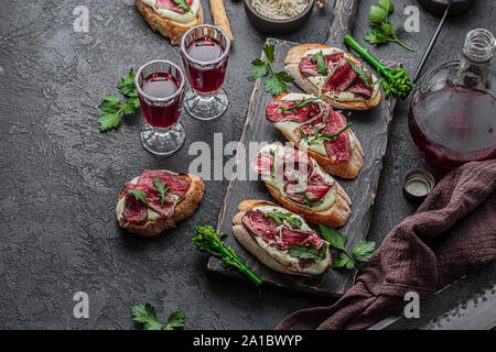 Crostini with Beef Tartare and Rocket, copy space. Stock Photo