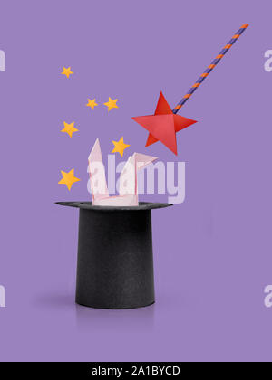Magic wand with rabbit ears in cylinder hat Stock Photo