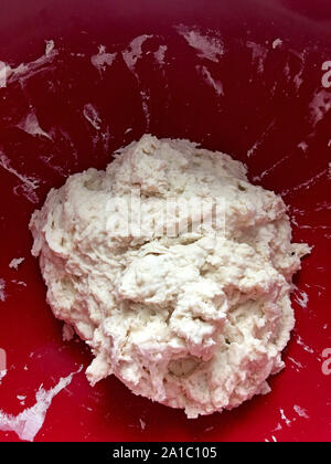 No need white bread dough in a plastic bowl ready to be baked Stock Photo