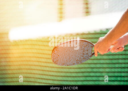 man playing beach tennis on a beach Stock Photo