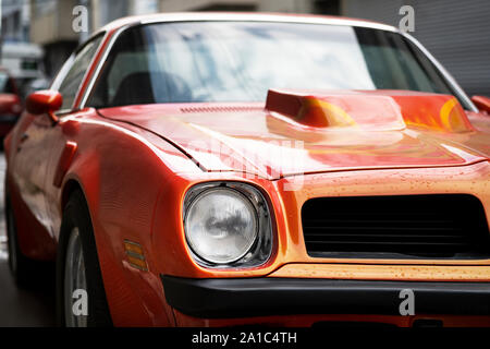 Izmir, Turkey - September 25, 2019: Front view of a Orange colored Pontiac Trans Am Classic car. Single head light seems. Stock Photo