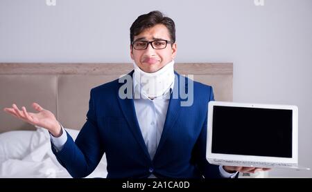 The businessman with neck injury working from home Stock Photo