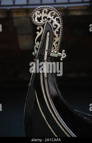 A close up of the ornamental bow of a gondola on the Grand Canal in Venice, Italy. Stock Photo