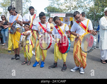 Young boys in traditional clothing play the drums at Smokey Park at the Madrassi Parade for unity in the community. In Richmond Hill, Queens. Stock Photo