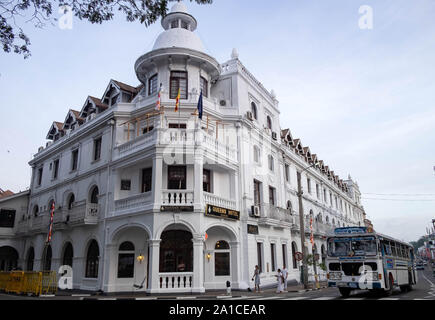 KANDY, SRI LANKA - AUGUST 04, 2019: Exterior of the historical building of the Queen's hotel in Kandy, Sri Lanka. And the local bus for go everywhere Stock Photo