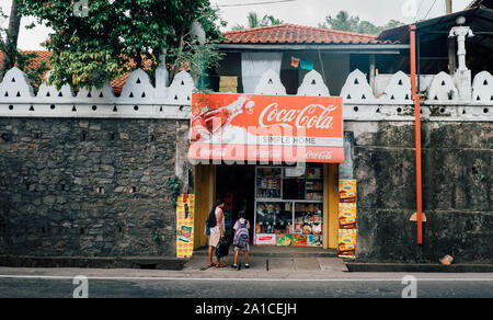 KANDY/ SRI LANKA, AUGUST 04, 2019: Little shops, small business in the streets of the small town with the blur of the motorcycle. Stock Photo